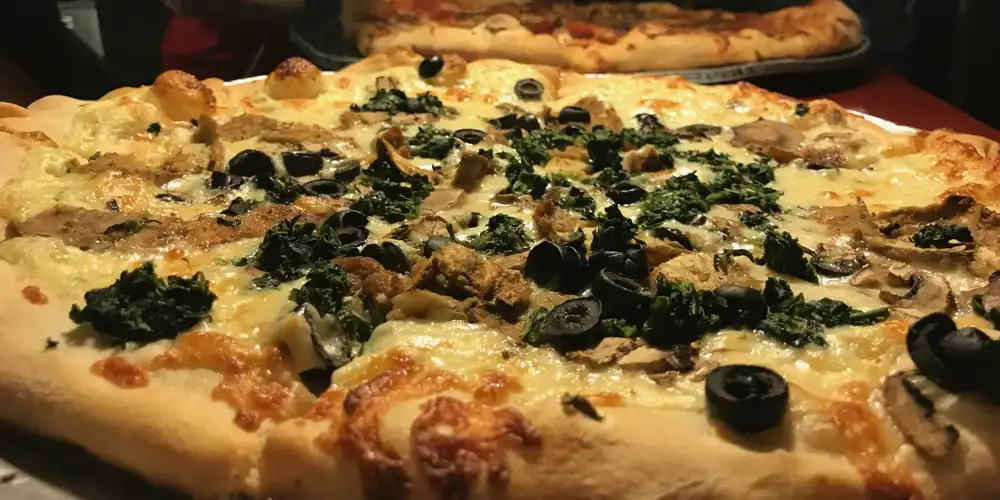 pizza with olives and spinach